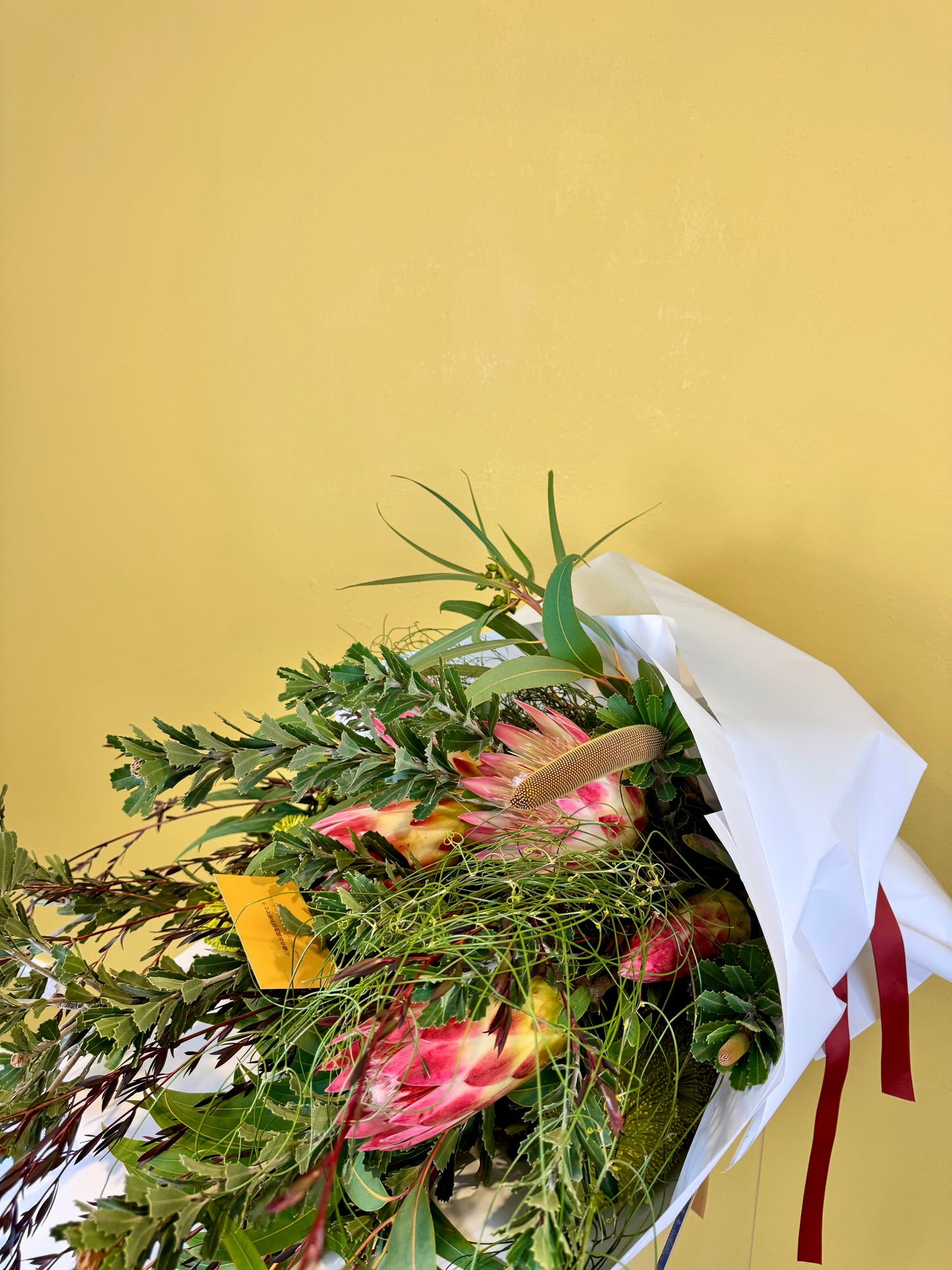 Bouquet of Australian Native Flowers  such as Banksia, Protea and Wattle wrapped in White paper